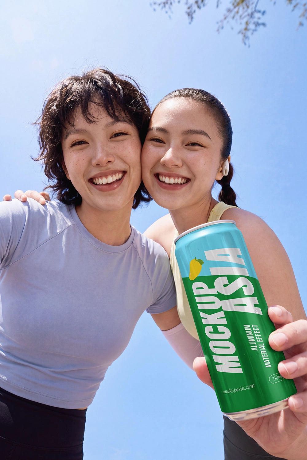 Realistic beverage can mockup with two models under summer sunlight