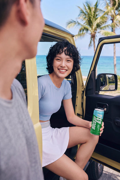 Sleek beverage can mockup held by a model inside a car
