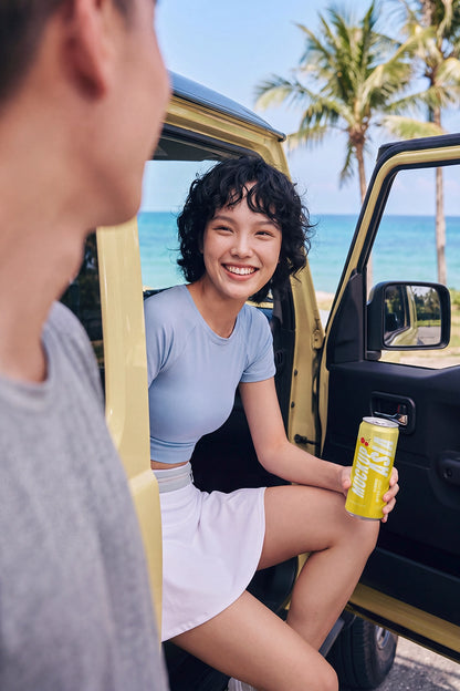 Beverage can PSD mockup in a sunny summer road trip scene
