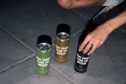 Aluminum can packaging mockup with a hand reaching toward one of three cans.