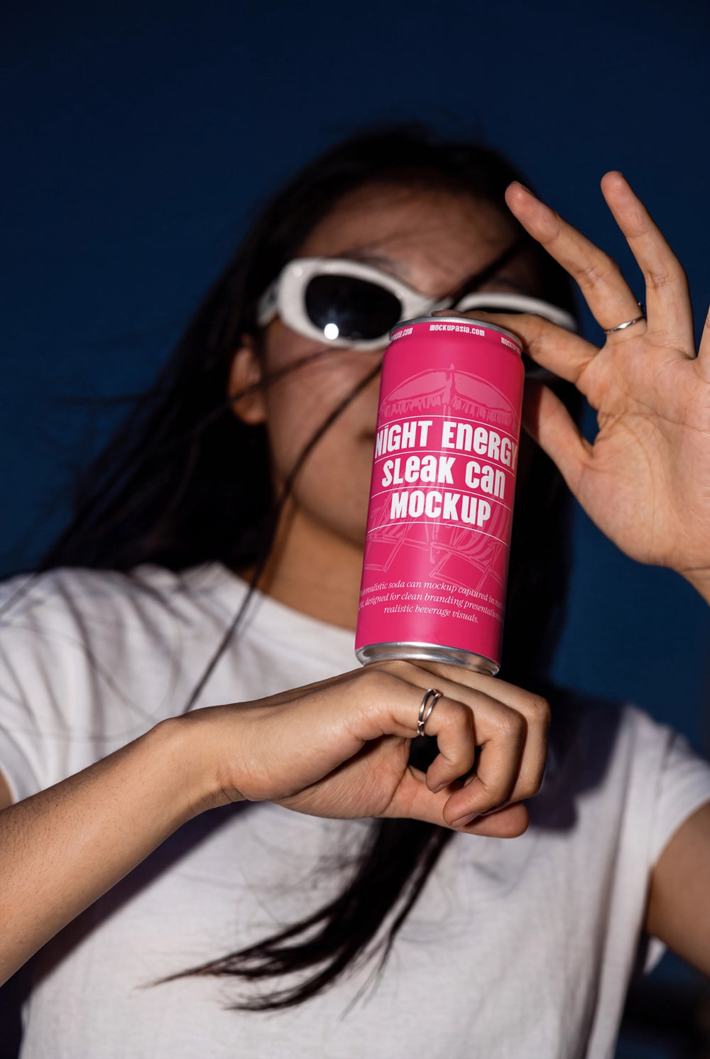 Lifestyle aluminum can PSD mockup held by hands against a dark blue background.