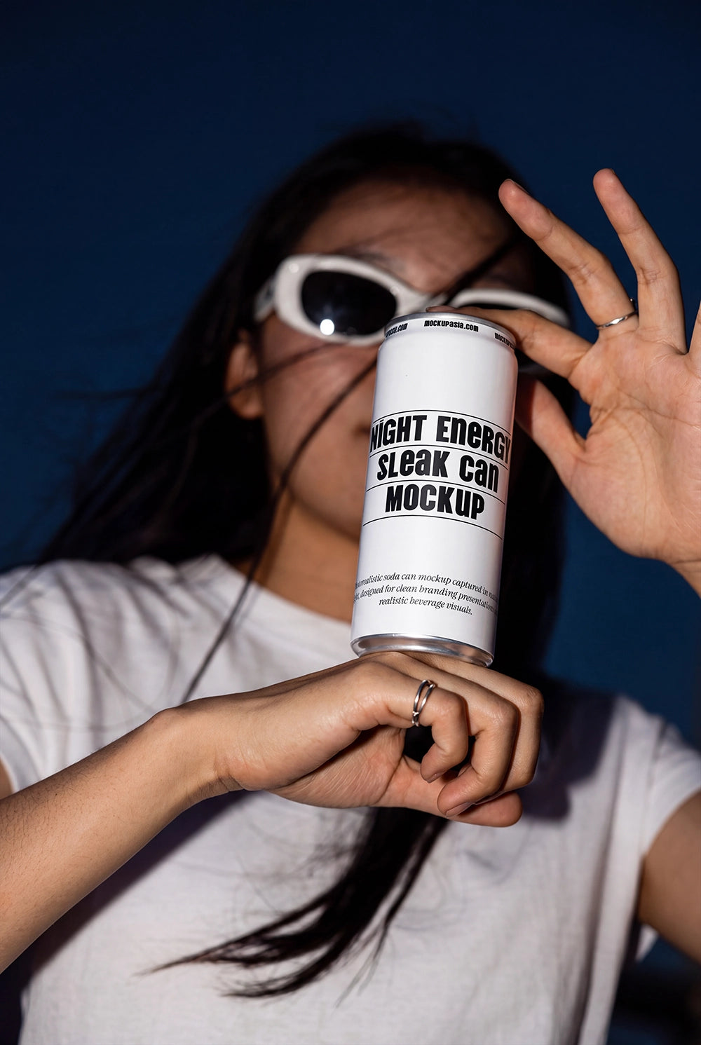 Sleek aluminum can mockup held in a lifestyle flash photography scene.