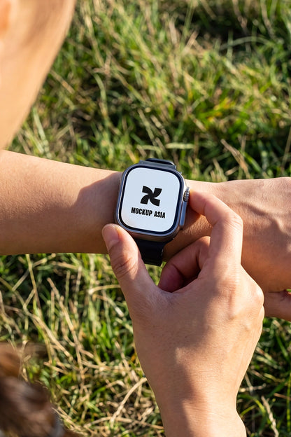 smartwatch mockup close up on wrist with hand interaction and outdoor grass background