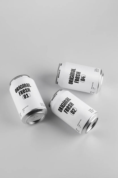 Three soda cans mockup top view scattered layout aluminum beverage packaging realistic minimal design