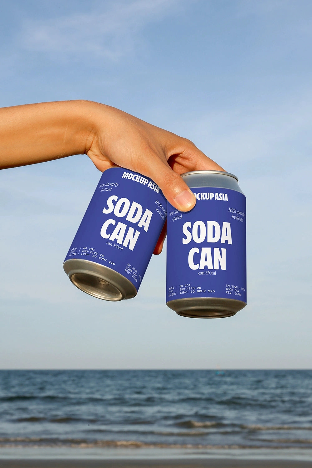 realistic beverage can mockup with hand interaction and seaside lifestyle setting