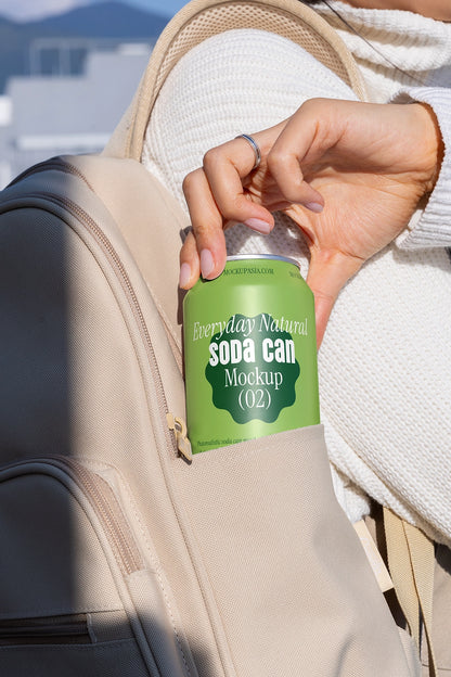 Aluminum soda can mockup in hand from backpack realistic on the go packaging PSD presentation