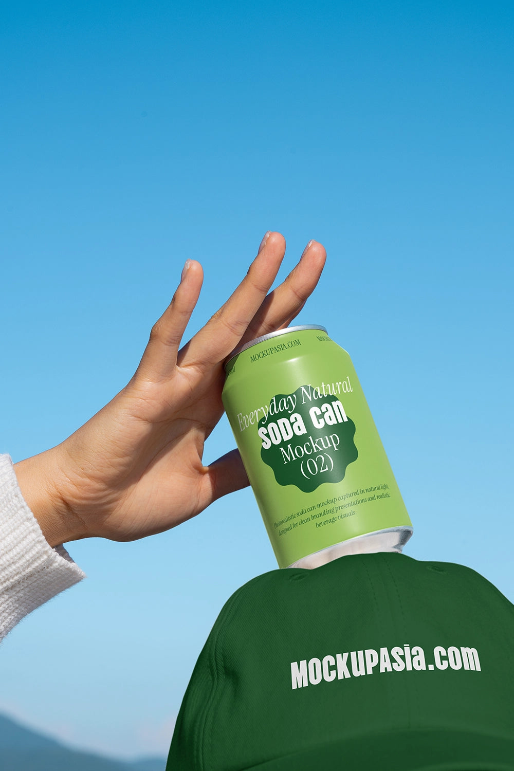 Drink can mockup in hand above hat clean sky background natural light branding template