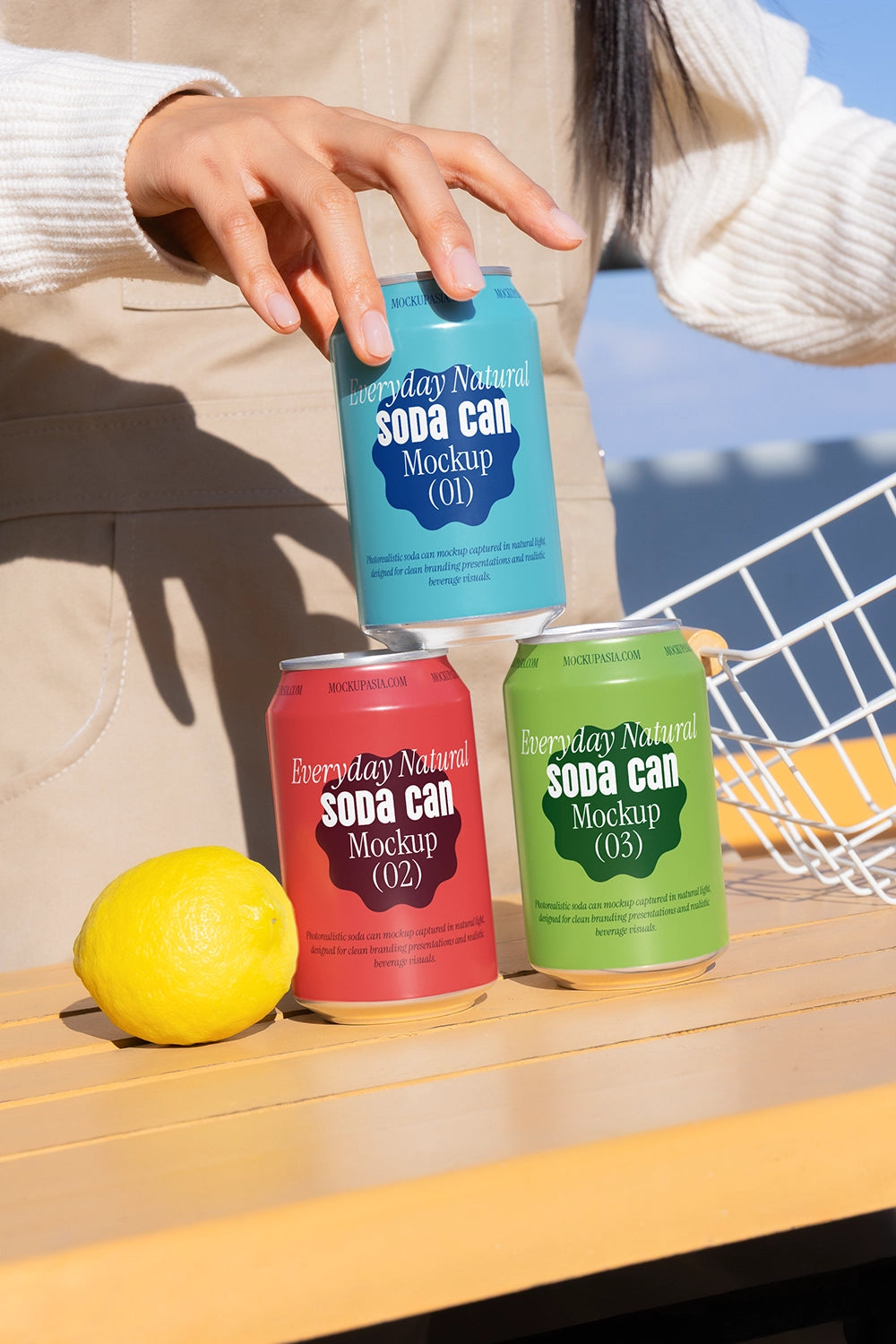 Drink can mockup set with hand interaction lemon and basket natural light branding template