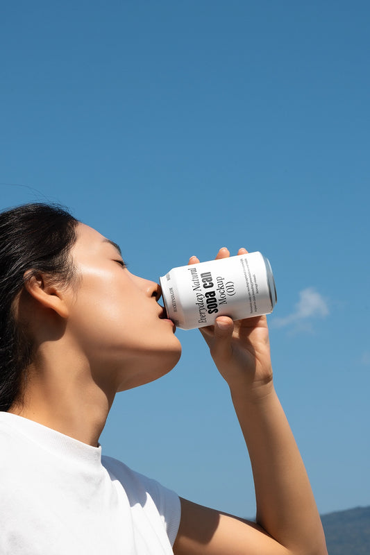 Person drinking from soda can mockup outdoor sky lifestyle aluminum beverage packaging scene