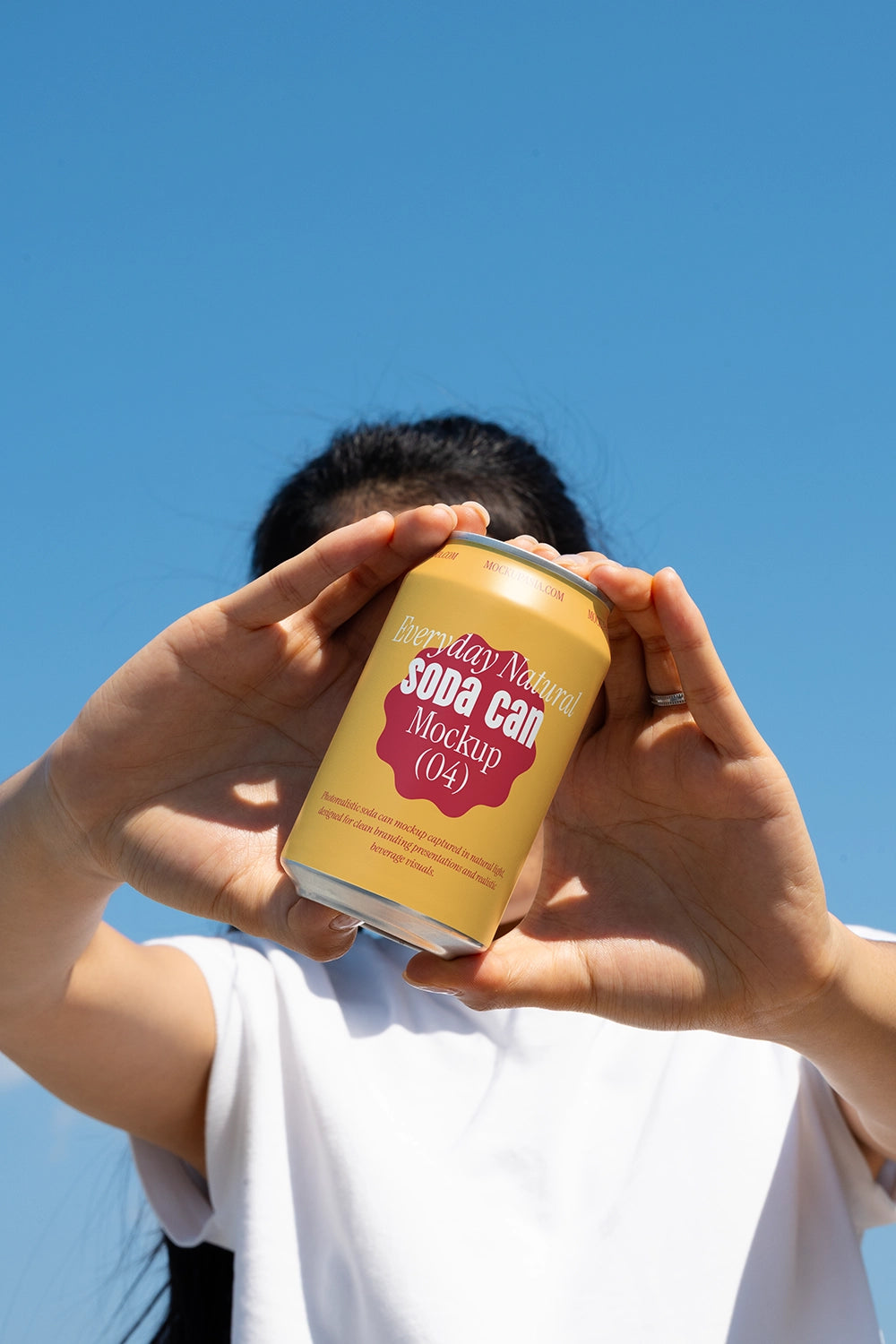 Drink can mockup framed by hands natural light sky background branding presentation template