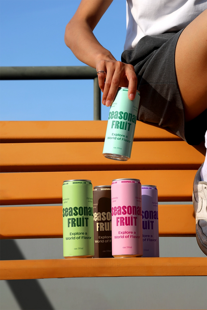 Aluminum beverage cans mockup arranged on orange bench with natural lighting for soda and energy drink branding