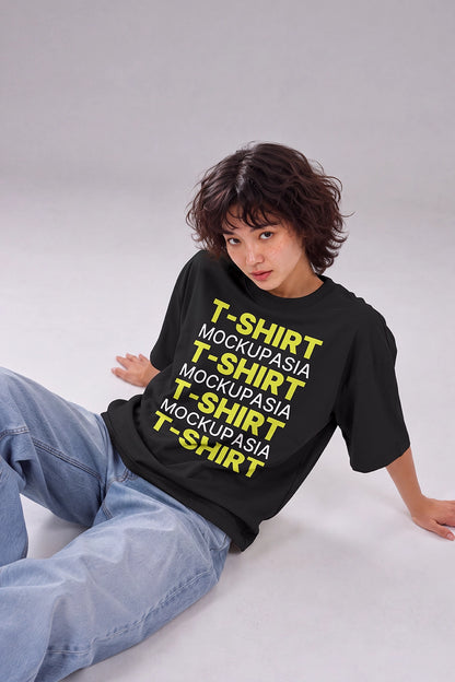 oversized t-shirt mockup on seated female model in minimalist studio