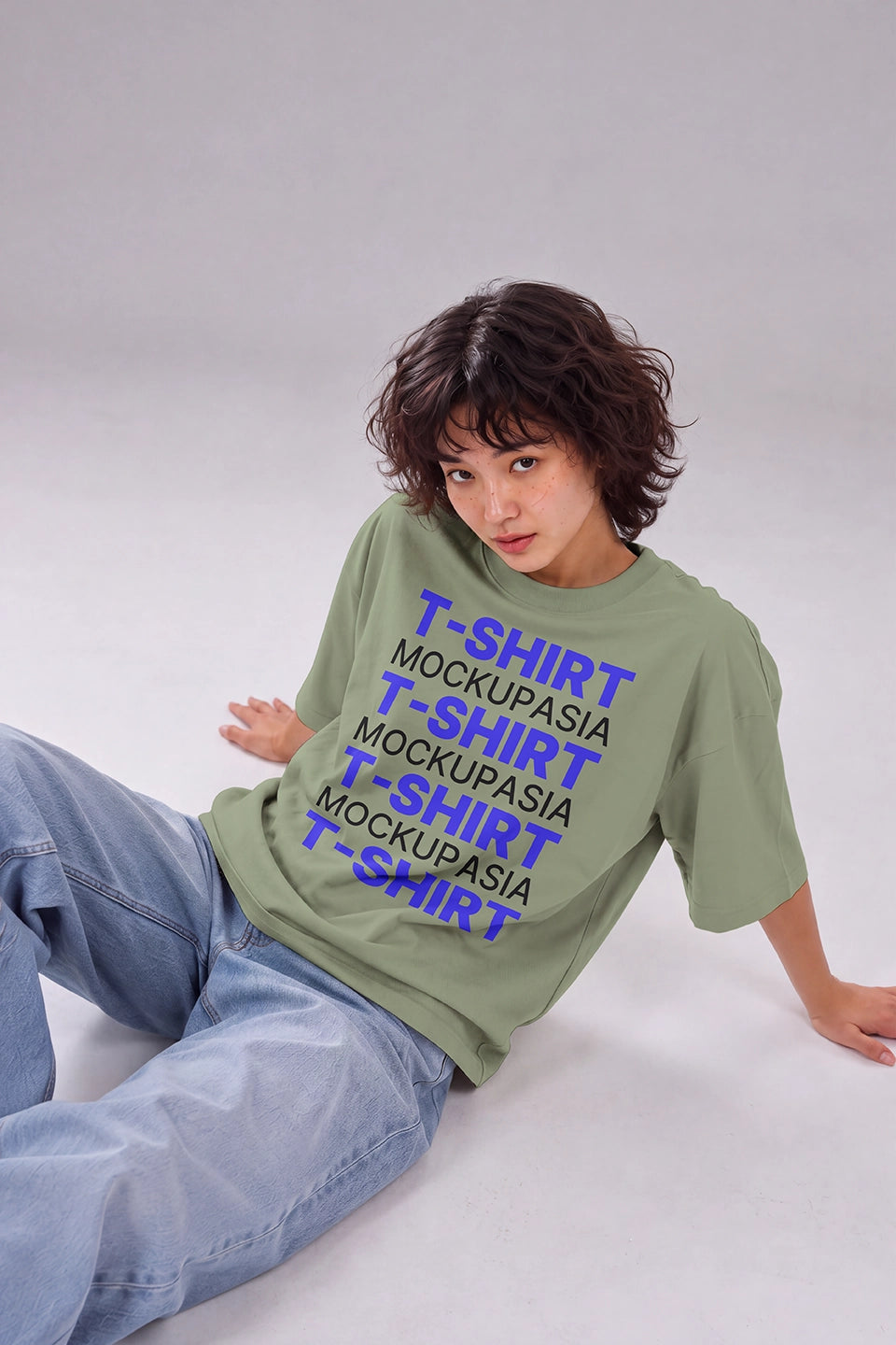 blank oversized tee mockup on female model wearing jeans in studio