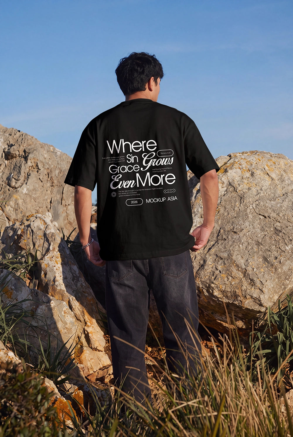 Editorial outdoor T-shirt mockup showing a back view of a male model.