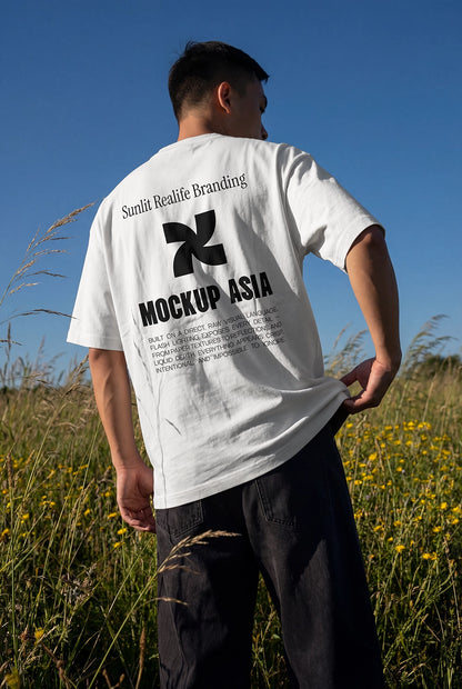 t shirt mockup back view on model with natural sunlight and outdoor grass field background