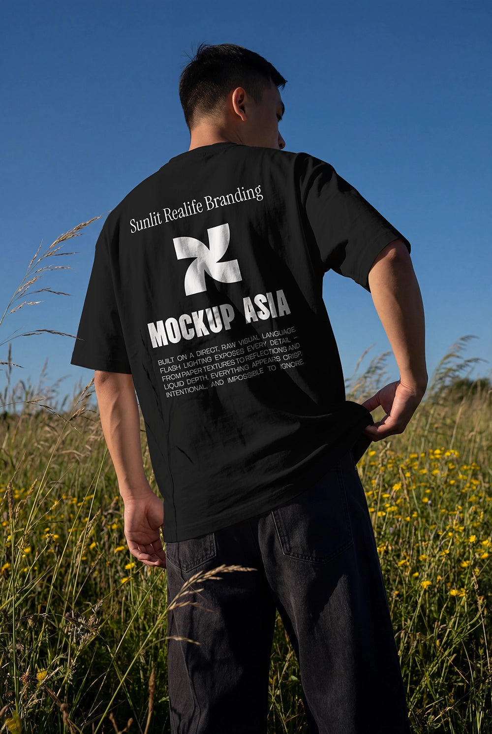 realistic t shirt mockup worn by person from behind with sky and field natural lighting