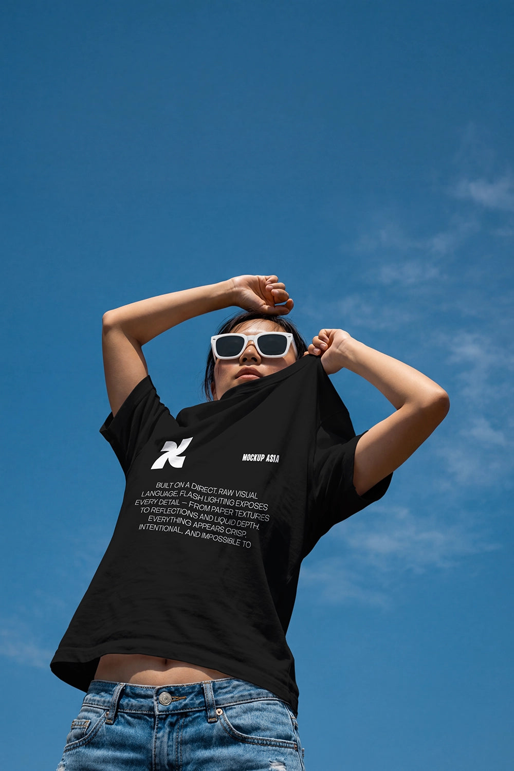 realistic t shirt mockup worn by person lifting shirt with outdoor sky background