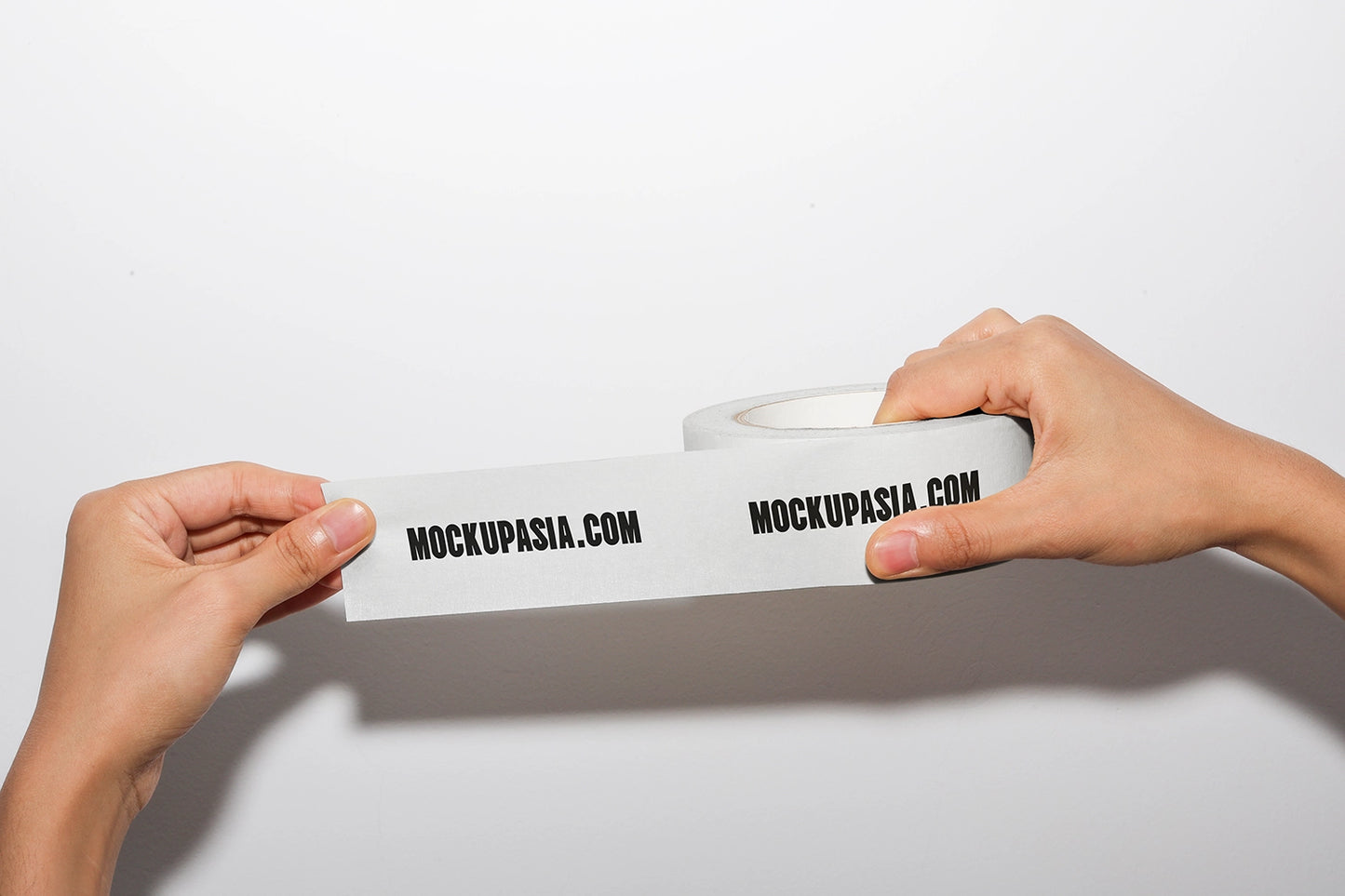 masking tape mockup stretched between hands with printed branding and clean background