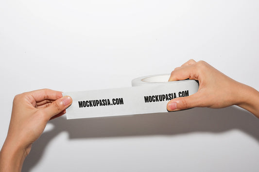 masking tape mockup stretched between hands with printed branding and clean background
