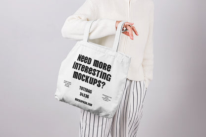 tote bag mockup held in hand with minimal design and clean studio background
