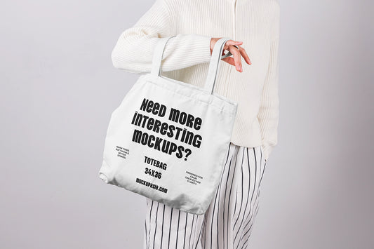 tote bag mockup held in hand with minimal design and clean studio background