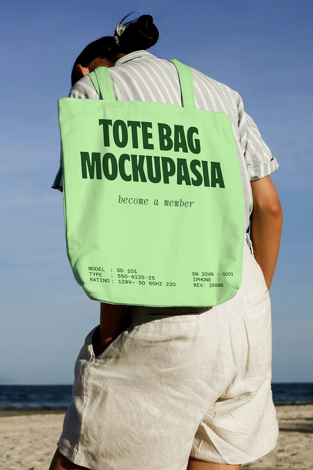 eco tote bag mockup carried on shoulder with minimal design and outdoor environment
