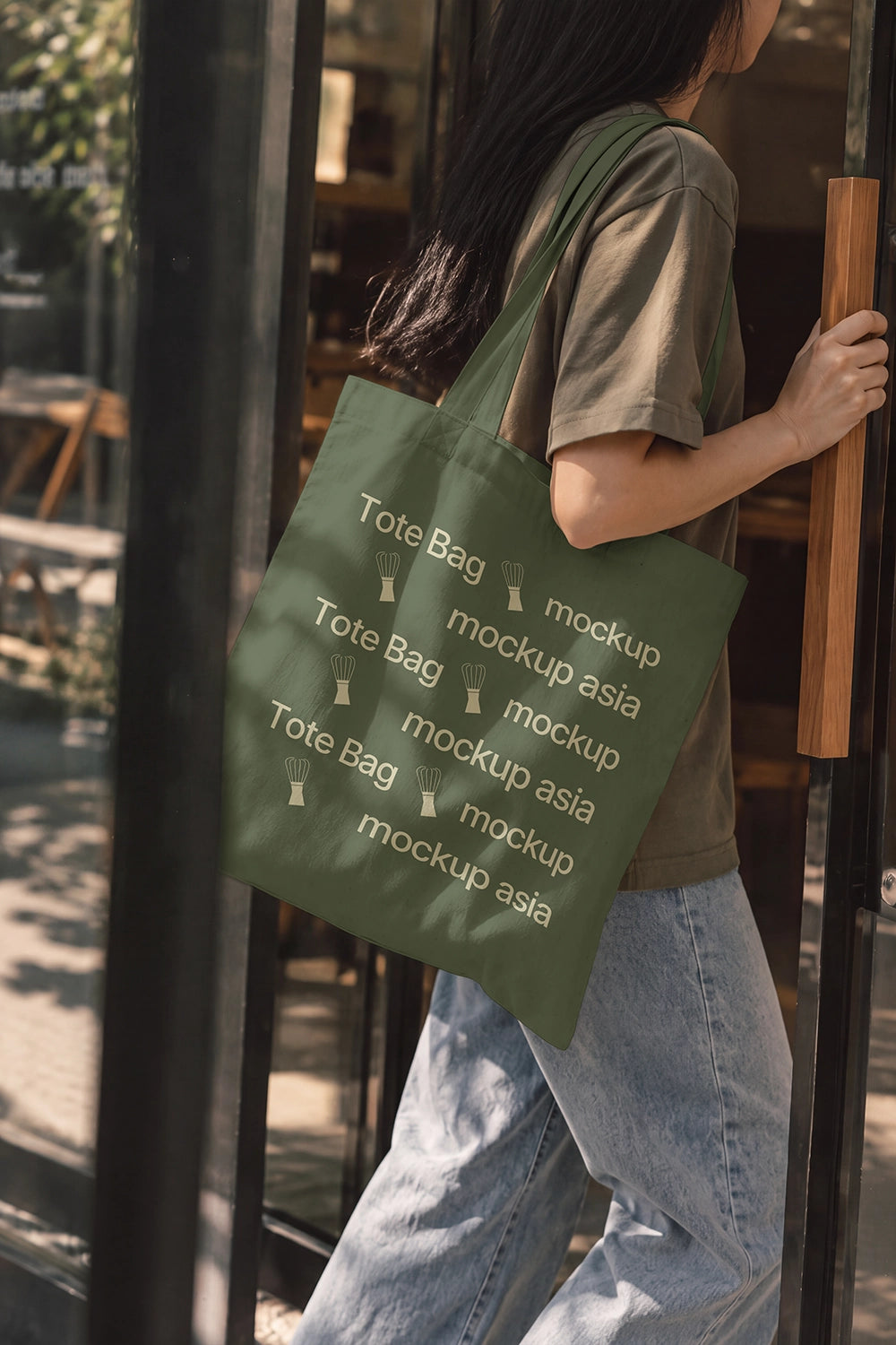 Woman carrying canvas tote bag mockup entering coffee shop
