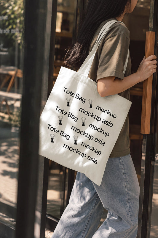 Tote bag mockup PSD with model carrying on shoulder at café door