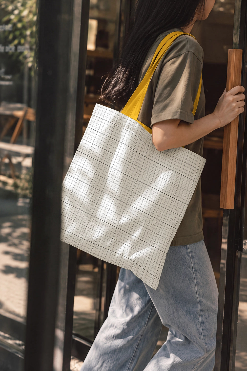 Cotton tote bag mockup worn by model editable smart object PSD