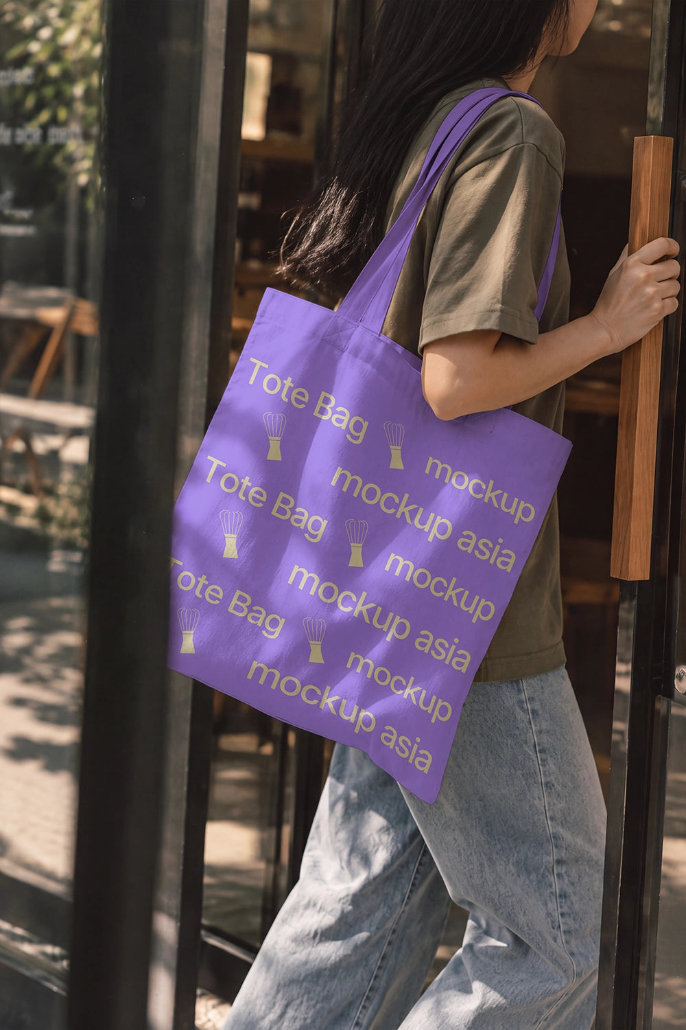 Café merch tote bag mockup lifestyle scene olive tee and jeans