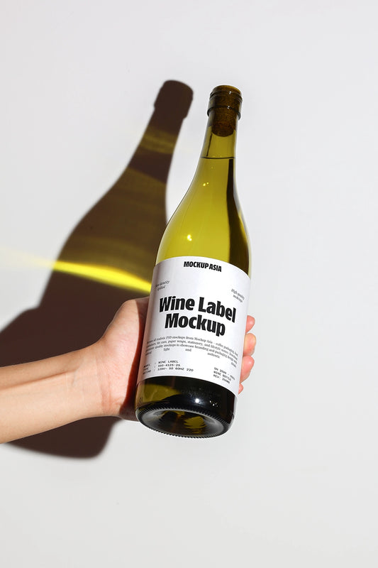 wine bottle mockup held in hand with dramatic shadow and minimal background