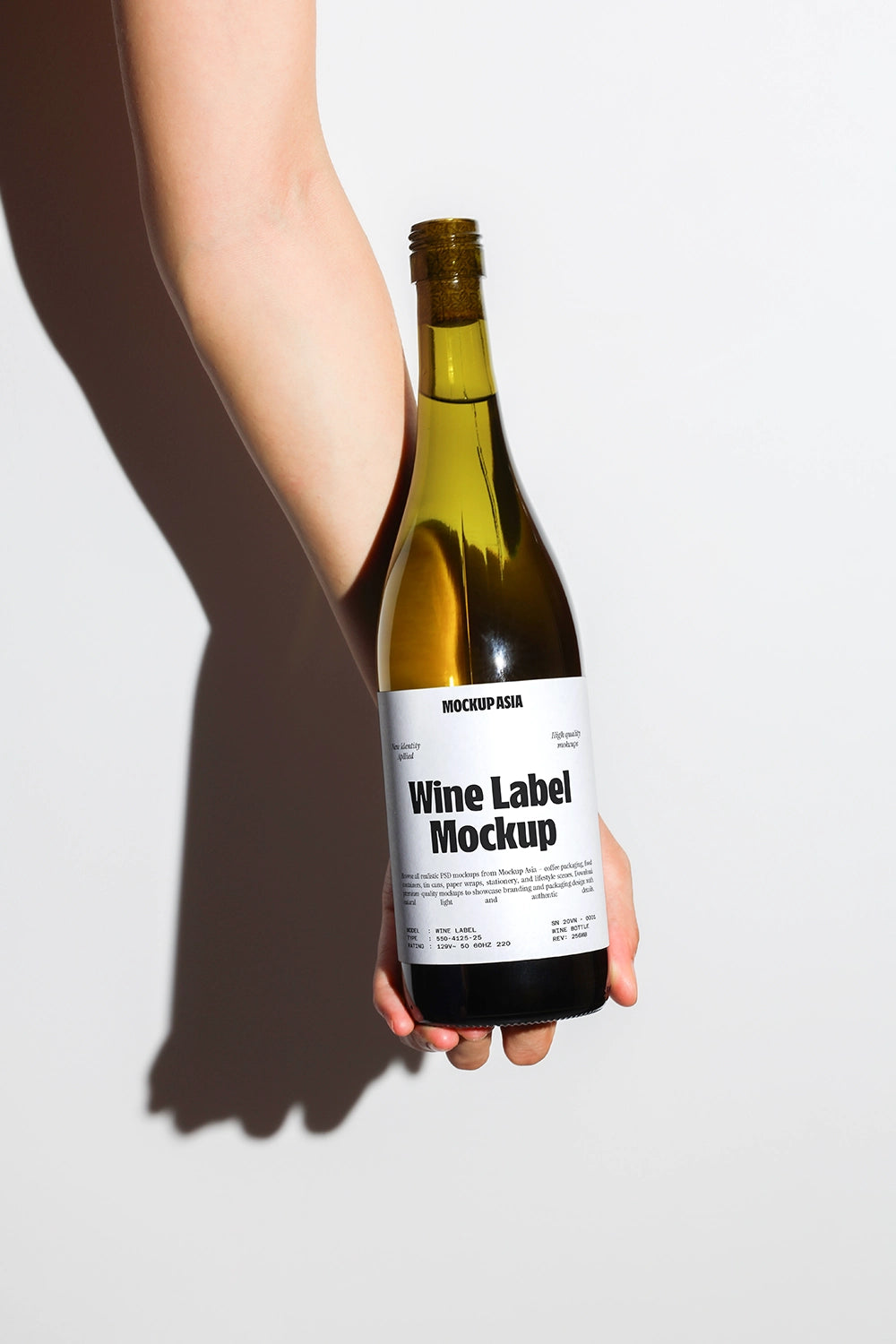 wine bottle mockup held by hand with strong shadow and minimal clean background