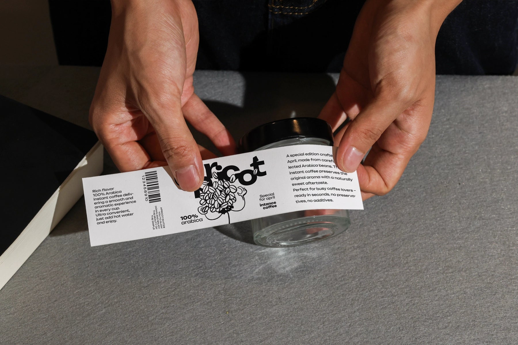 wrap label mockup applied to glass jar with hands close up