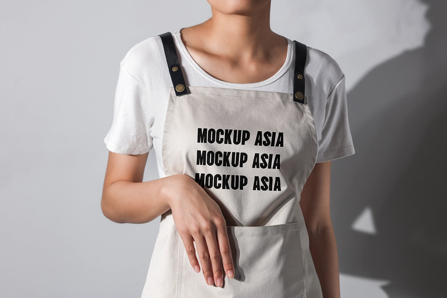 apron mockup worn by model with hand pose and natural studio lighting realistic fabric texture