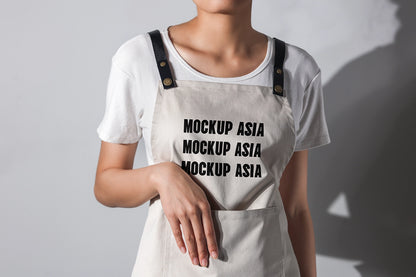 apron mockup worn by model with hand pose and natural studio lighting realistic fabric texture