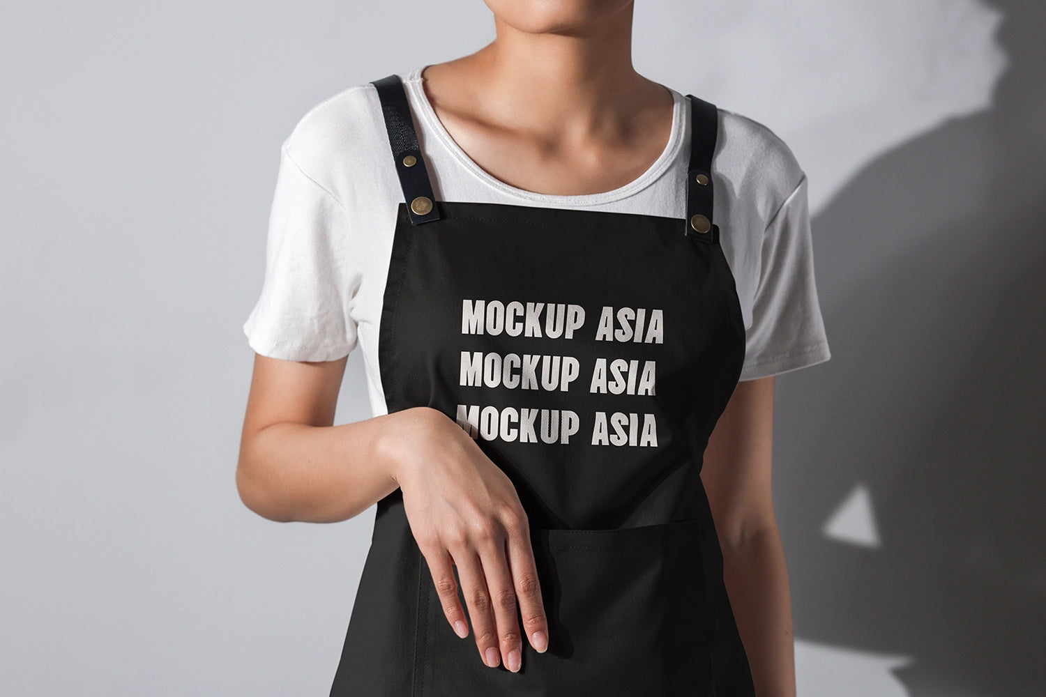 realistic apron mockup on person with hand in pocket soft shadow and minimal background