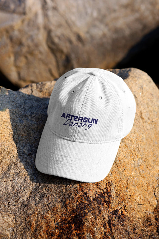 baseball cap mockup on rock surface with natural sunlight and realistic shadow outdoor scene