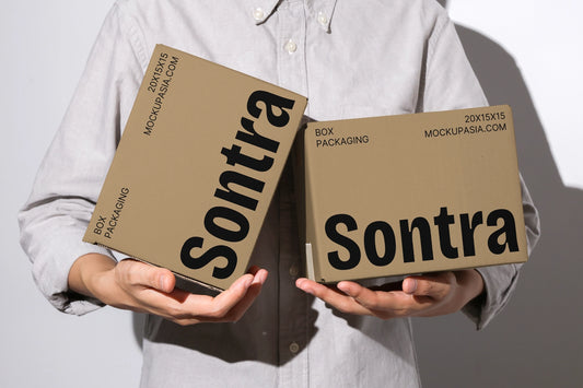 Kraft box mockup with two cardboard boxes held in hands front view minimal background