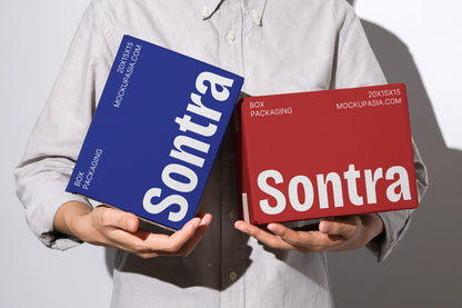Packaging box mockup with brown boxes and bold typography branding handheld presentation