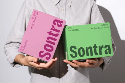 Shipping box mockup with two parcel boxes displayed in hands realistic lighting