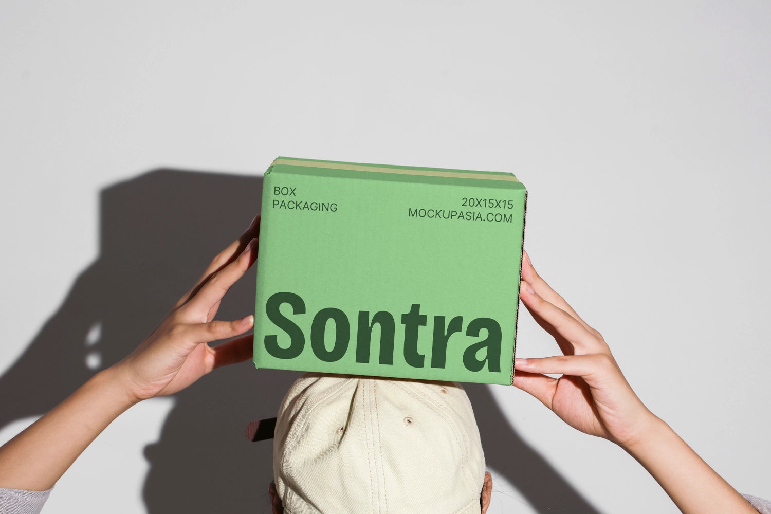 Cardboard box mockup set held in hands with multiple packaging boxes minimal background