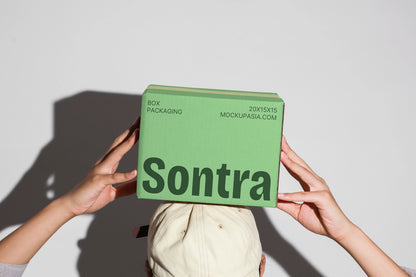 Cardboard box mockup set held in hands with multiple packaging boxes minimal background