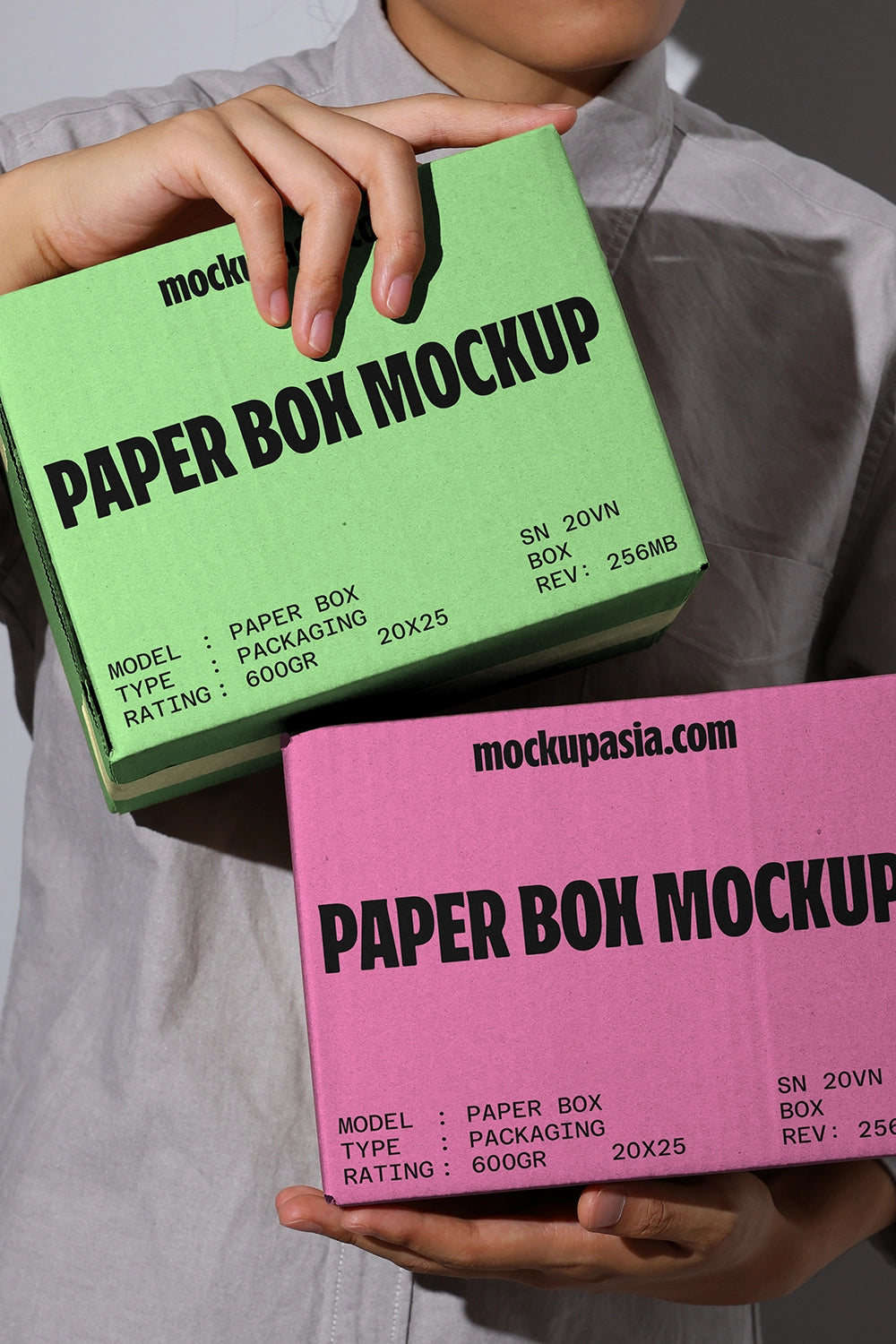 Packaging box mockup with bold typography paper boxes in handheld presentation