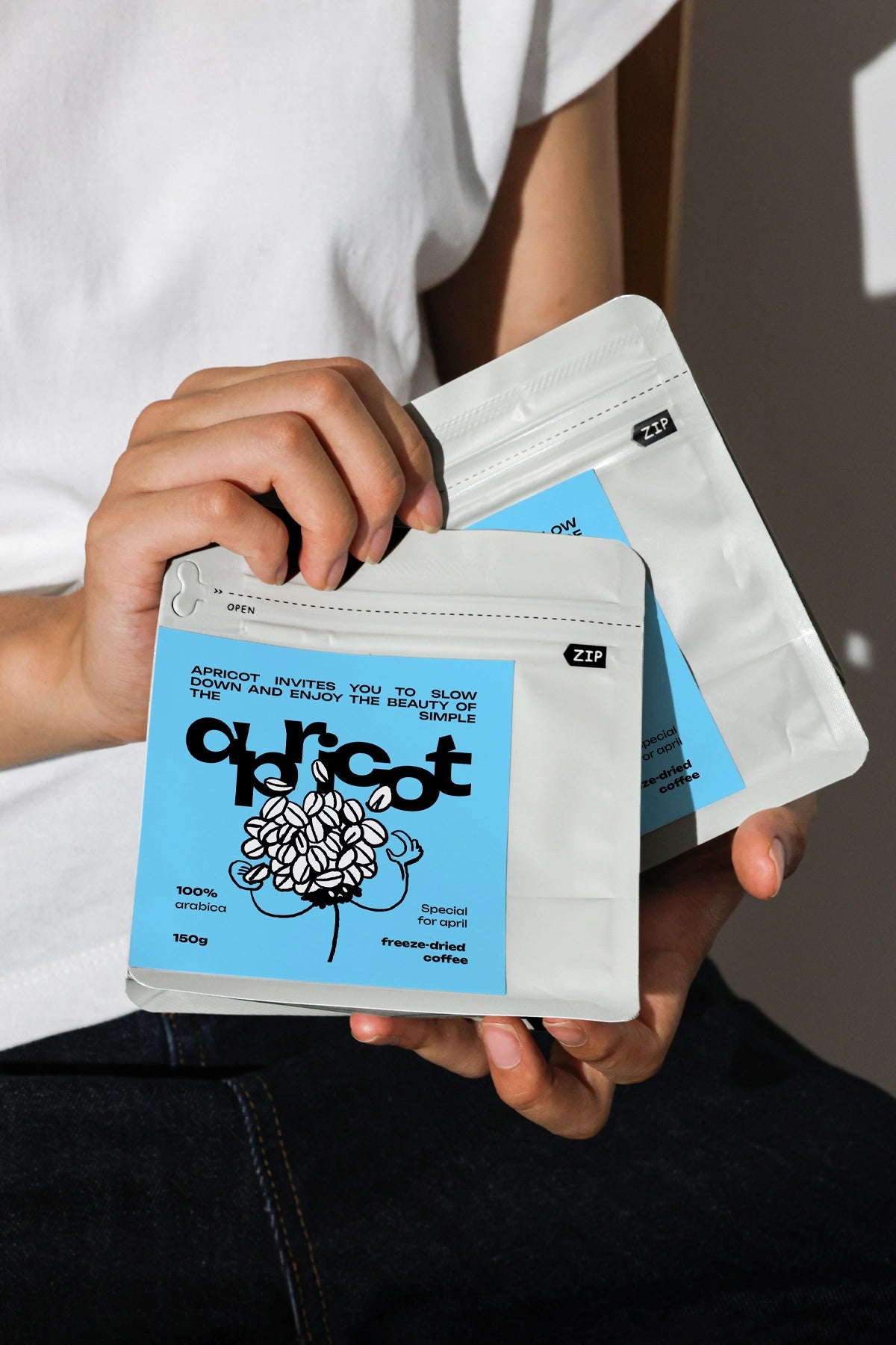 stand up pouch mockup with zip lock held by hand, realistic coffee packaging branding scene