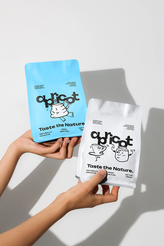 Handheld coffee bag mockup with blue and white pouches, clean branding in natural daylight