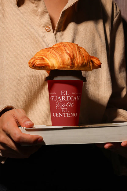 coffee cup mockup with croissant on top, warm lighting and editorial food styling