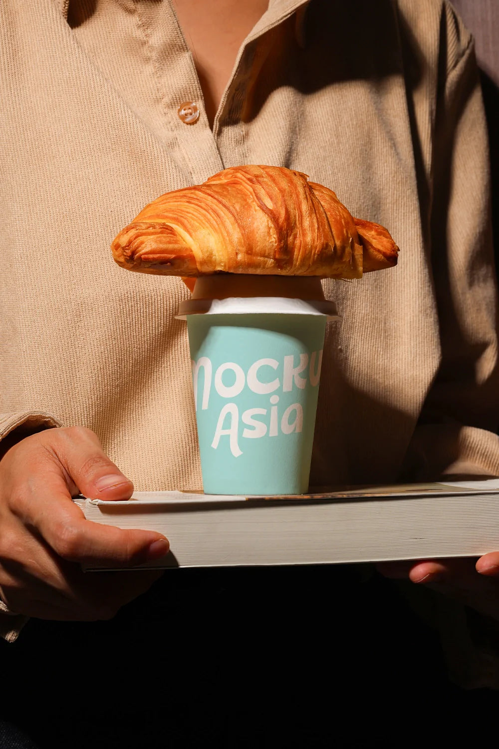 paper cup mockup with pastry on top, lifestyle cafe branding scene with strong shadows