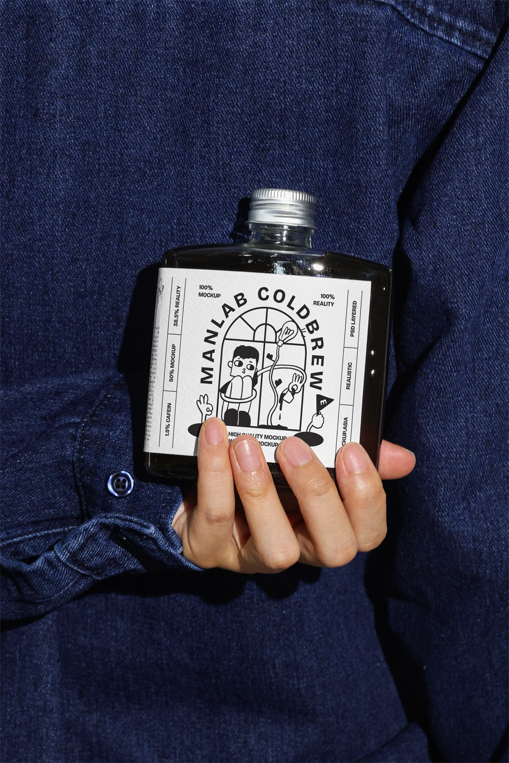 Hand holding cold brew bottle mockup with realistic lighting and denim background