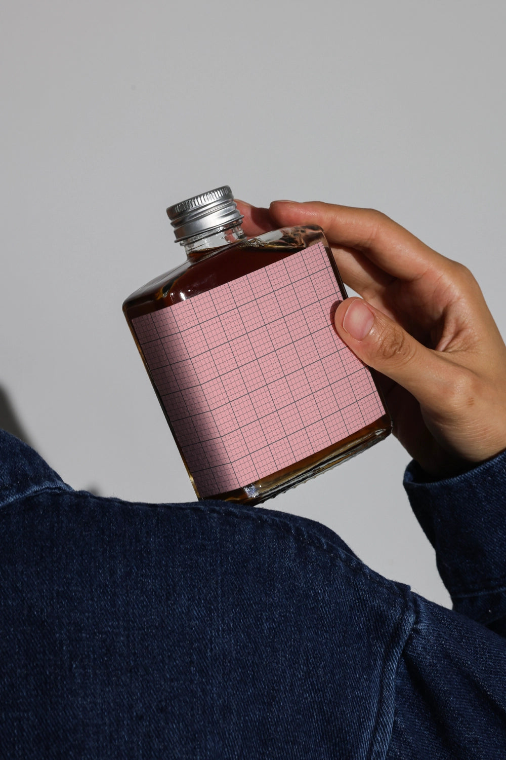 Cold brew bottle mockup in tilted position showcasing minimalist label design

