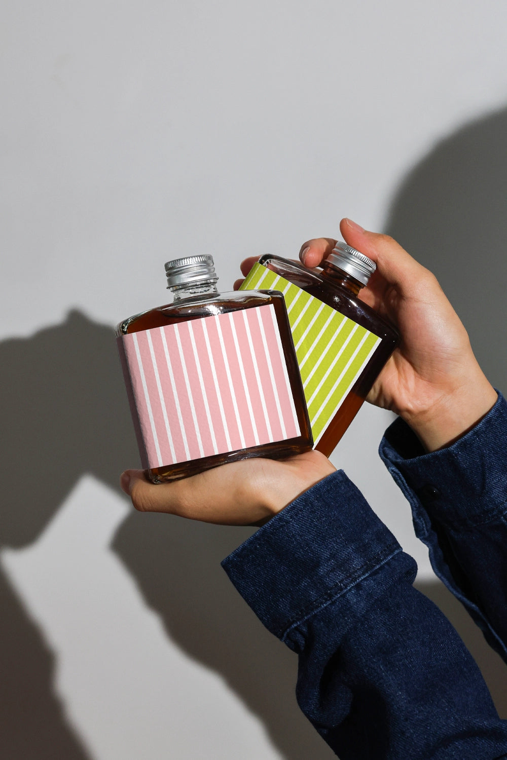 Coffee bottle mockup with two bottles for branding comparison in lifestyle scene
